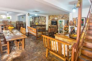 a living room with wooden furniture and a dining room at Pousada Portal in Tiradentes