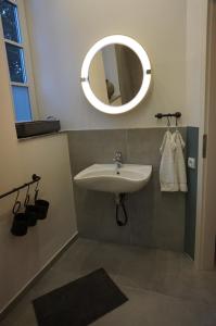 a bathroom with a sink and a mirror at Bahnhof Vaale • Fliegender Hamburger in Vaale