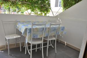 a table with chairs and a table cloth on it at Guest House Cikaj in Durrës