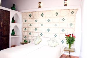 Postel nebo postele na pokoji v ubytování Riad Ben Youssef