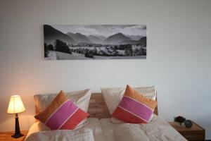 a bedroom with a bed with two pillows on it at Alpenflair Ferienwohnung Whg 108 in Oberstdorf