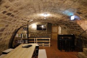 a wine cellar with a table in a stone wall at Hotel Fairista Quedlinburg in Quedlinburg
