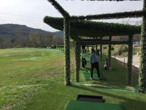 a person playing a game of golf in a field at FAME - Marina baie des Anges in Villeneuve-Loubet