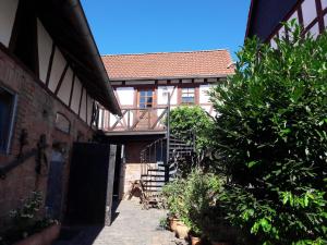 a building with a stairway leading into a courtyard at Diebacher Hof in Büdingen