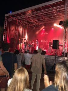 a group of people watching a band on a stage at On the Beach in Lacanau-Océan