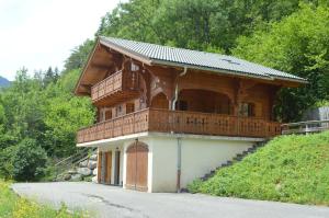 a house with a balcony on the side of a road at Chalet La Rose in Montriond