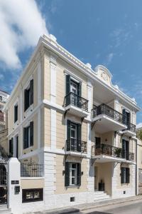 a white building with balconies on the side of it at The Anthemion House in Kavála