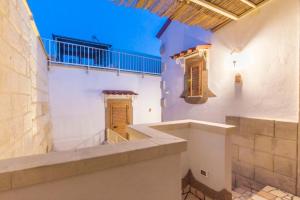 a room with white walls and a staircase in a building at Dimora Corte antica in Scorrano