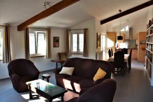 a living room with a couch and a table at La Bordette in Valeilles