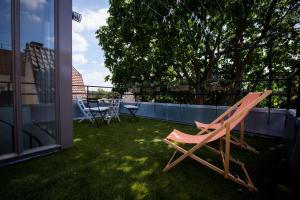 ein rosa Stuhl, der auf dem Gras auf einem Balkon steht in der Unterkunft Aan de Dieze in ’s-Hertogenbosch