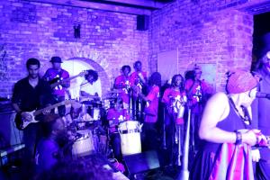 a group of people standing in a room with instruments at hotel florita in Jacmel