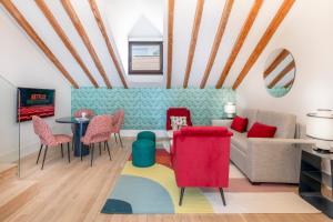 a living room with a couch and chairs and a table at Slow Suites Chueca in Madrid