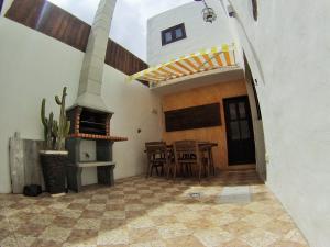 a patio with a stove and a table and chairs at Luana House in Teguise