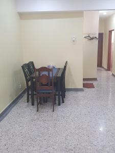 a dining room with a table and chairs at Maha Hotel in Puchong