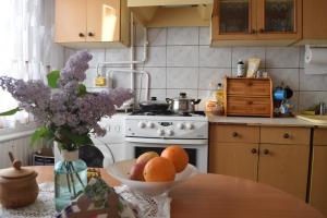 a kitchen with a bowl of fruit on a table at Cozy self check-in private room in the city centre in Mažeikiai