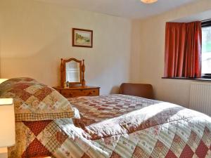 A bed or beds in a room at The Linhay 