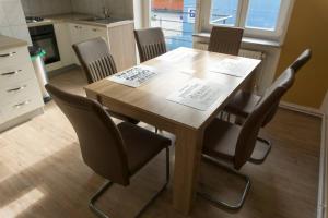 a wooden table with four chairs in a kitchen at Trendy apartmant in city in Maribor