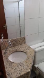 a bathroom with a sink and a toilet at Vital Hotel in Marechal Floriano