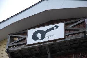 a sign for a tuning farm on the side of a building at Pension Fryingpan in Niseko