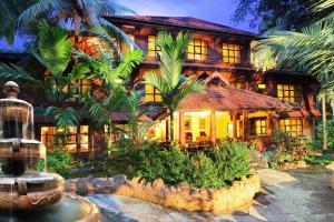 a house with a fountain in front of it at Emarald Resort in Pulamanthole