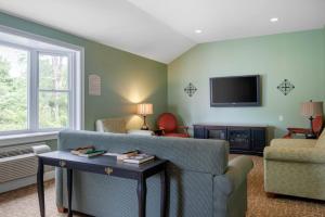 a living room with a couch and a tv at Coachman Inn in Kittery