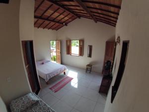 a bedroom with a bed in a room at Family Guest House in Ilha de Boipeba