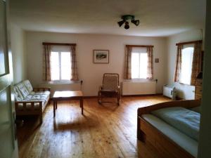 a living room with a couch and two windows at Ferienhaus Herrnbauer in Zaglau