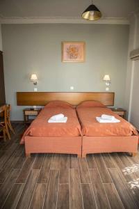 a bedroom with a bed with two napkins on it at Togias Hotel in Aegina Town