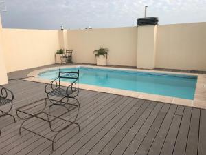 a patio with chairs and a swimming pool at Dpto ideal in Resistencia