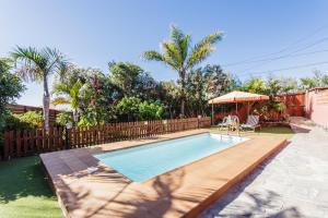 a swimming pool in a yard with a table and chairs at El Tendal in Puntagorda