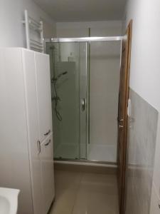 a shower with a glass door in a bathroom at hostel52 in Gdańsk