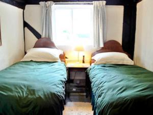 A bed or beds in a room at Watsons Farm 