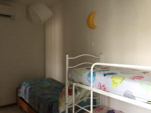 a bedroom with a bunk bed with a crescent moon on the wall at Appartamento Porto Prile CastiglioneD.P. in Castiglione della Pescaia
