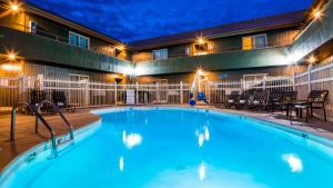 a pool in front of a hotel at night at RiverTree Inn & Suites in Clarkston