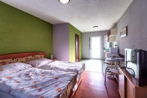 A bed or beds in a room at Apartmánový dom RED