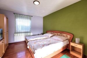 A bed or beds in a room at Apartmánový dom RED