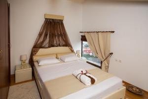 a bedroom with two beds and a window at Villa Deluxe Sight in Ioannina