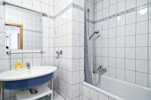 a white bathroom with a sink and a shower at Top Apartmentwohnungen Veltins Arena in Gelsenkirchen +36 photos