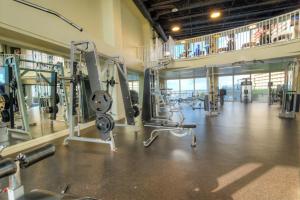a gym with several tread machines in a large room at Laketown Wharf Resort 631 By Aneliya in Panama City Beach