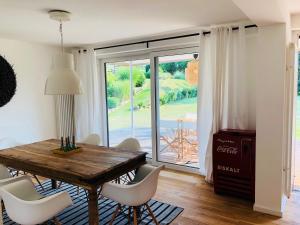 a dining room with a table and chairs and a sliding glass door at Ferienhaus mit Sonnendeck in Sankt Wendel