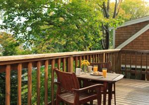 a table on a deck with two chairs and orange juice at The Provincetown Hotel at Gabriel's in Provincetown