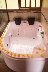 a bath tub with yellow flowers around it at Hosteria Quinta San Miguel in Ibarra