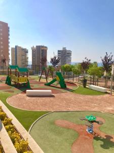a park with a playground with a swing at Sunset Drive Vistas Magicas in Benidorm