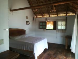 Tempat tidur dalam kamar di Cabañas La Isla Chacahua