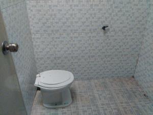 a bathroom with a white toilet in a shower at Setro Kariyo Homestay in Bantul +80 photos