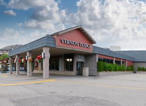 a view of a store with a sign that reads vivenonym lodge at Prestige Vernon Lodge in Vernon