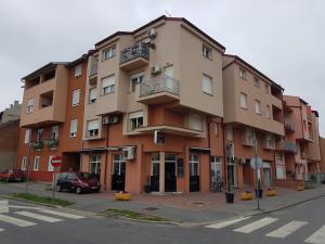 a large building on the corner of a street at City Inn Apartment in Osijek