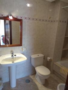 a bathroom with a toilet and a sink at Hostal Brisa do mar in Portonovo +19 photos