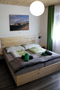 a bedroom with a large bed with a wooden frame at Nature Fun Apartments - Nassfeld - Pressegger See in Hermagor