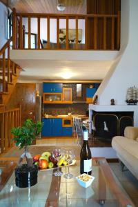 a living room with a table with a bottle of wine at Halkidiki Trikorfo Luxury Maisonette in Gerakini